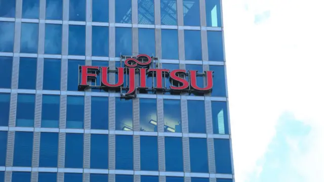 The logo of Japanese multinational information technology equipment and services company Fujitsu is seen on a skyscraper in Munich.