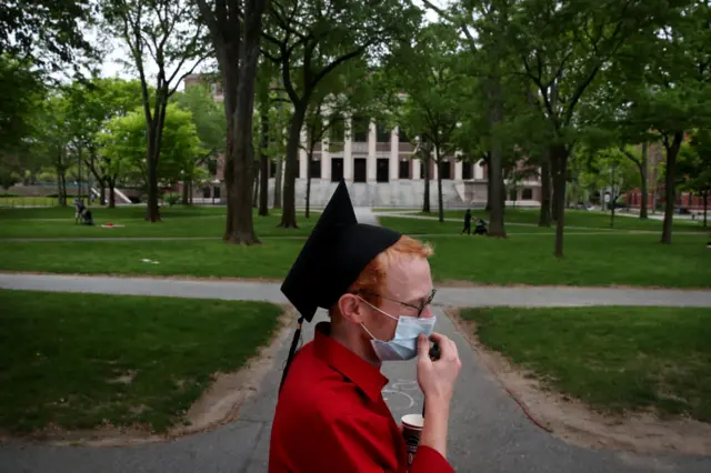 A Harvard University student wearing a mask