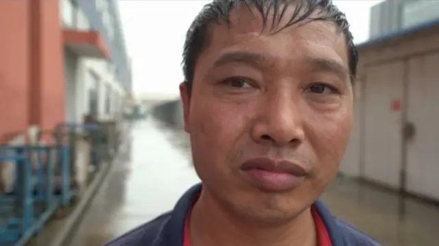 Factory worker Huang Xuefeng has seen his salary cut by 50%