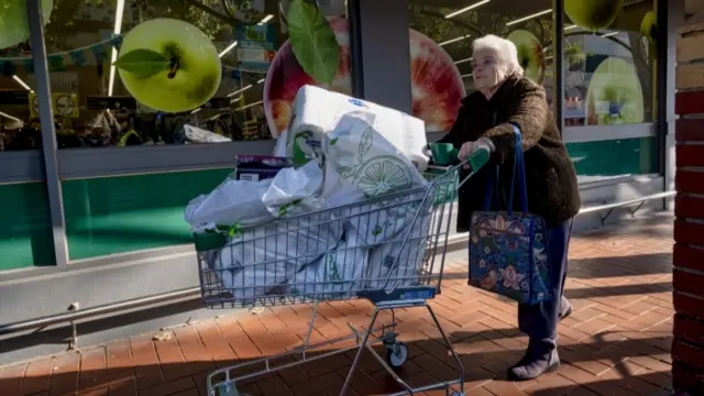 Woman with a full shopping cart