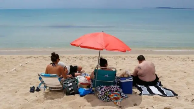 People sat on a beach