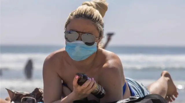 Woman wearing mask on beach