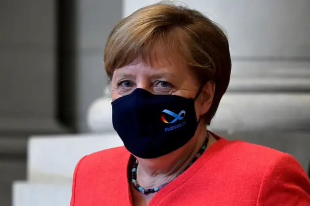 Angela Merkel in a face mask with the logo of Germany's EU presidency on it