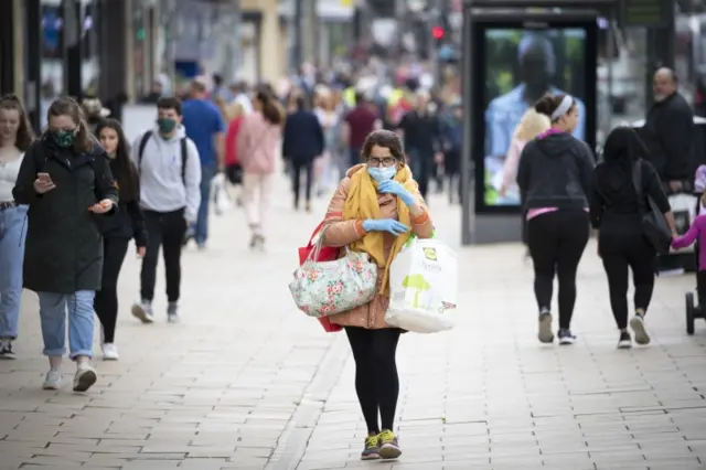 A shopper in a face covering