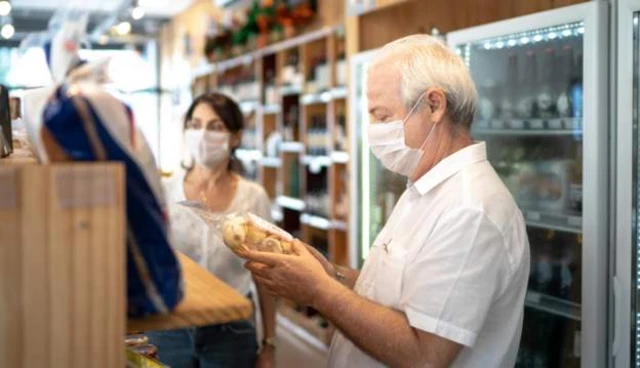 Staff members wear face coverings in a shop