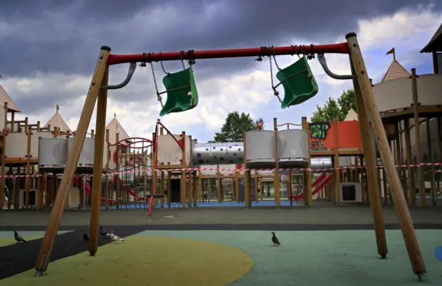 Swing chairs for kids are wrapped and locked onto the upper bar while the whole kids play installation in Bucharest, Romania