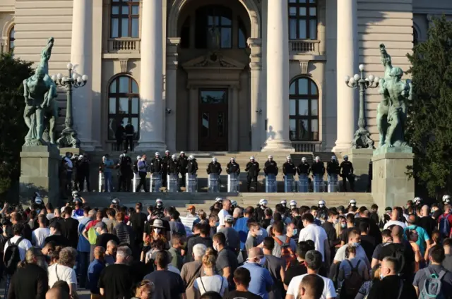 Police officers stand guard as demonstrators gather during an anti-government rally, amid the spread of the coronavirus disease (COVID-19), in front of the parliament building in Belgrade, Serbia, July 8, 2020