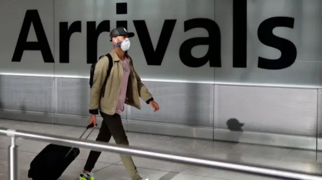 Passenger at airport arrivals hall