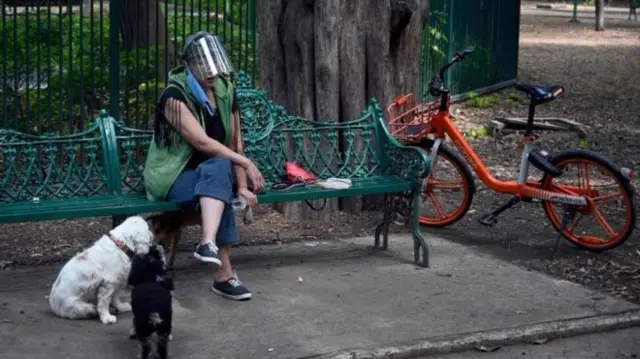 Woman on bench in visor