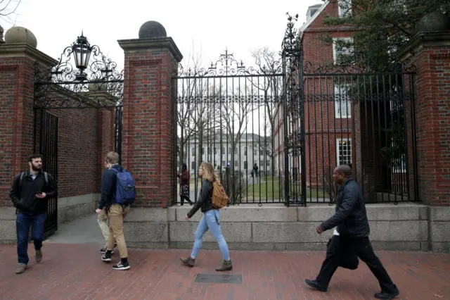 People walk through Harvard University's campus earlier this year