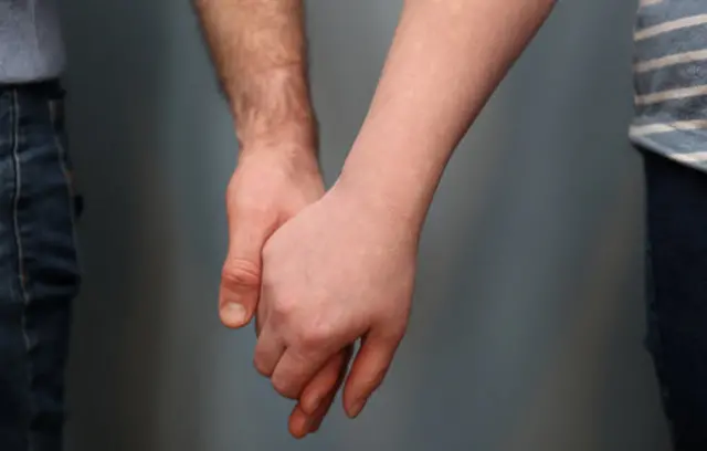 Couple holding hands