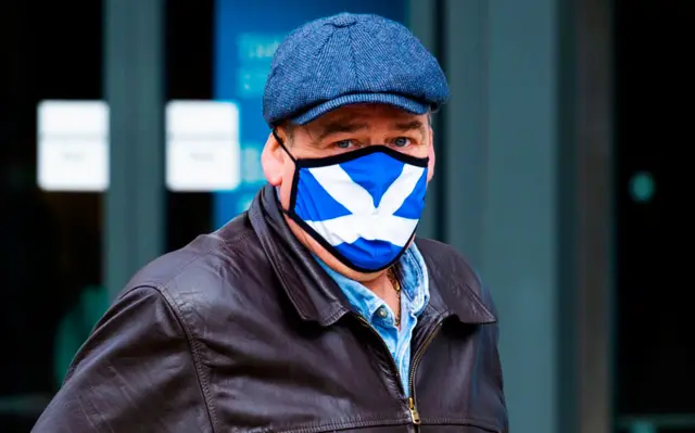 Man wearing a mask with a St Andrews flag