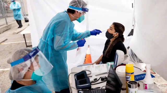 A woman is tested for coronavirus in Los Angeles