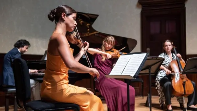 People playing musical instruments on a stage