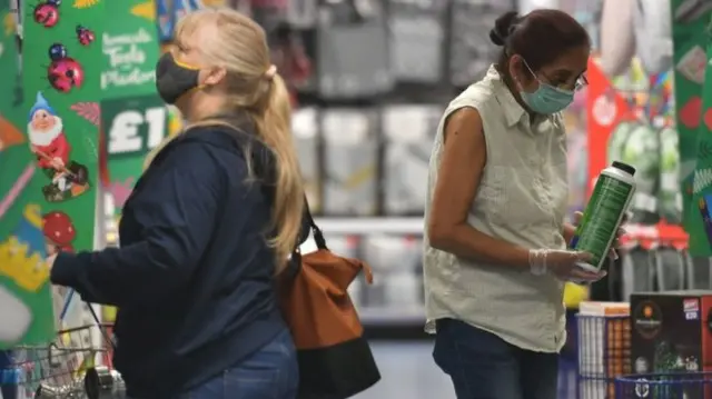 People shopping in the UK while wearing face masks