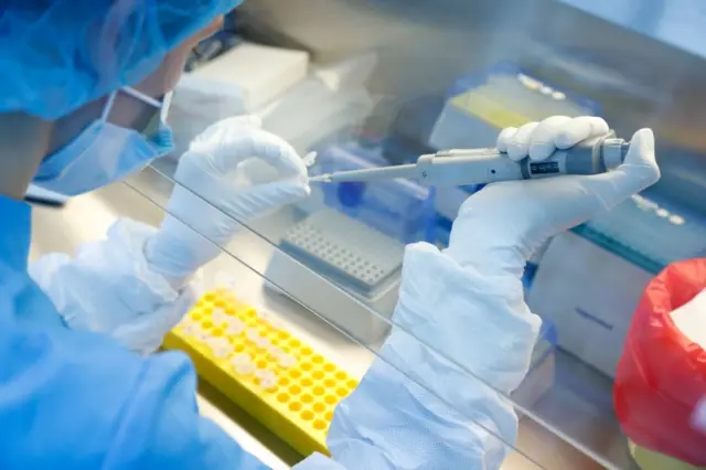 A scientist prepares samples during the research and development of a vaccine against the coronavirus disease