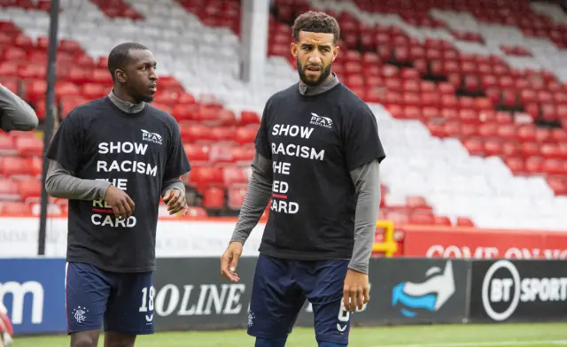 Players are wearing t-shirts with an anti-racism slogan while they warm up