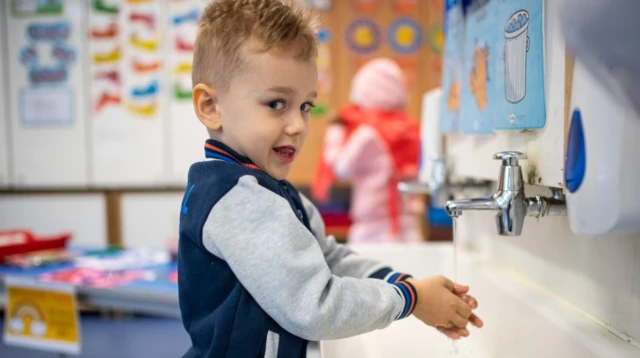 Boy washing his hands