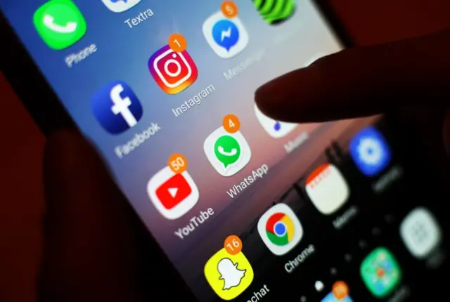 The icons of social media apps, including Facebook, Instagram, YouTube and WhatsApp, displayed on a mobile phone screen