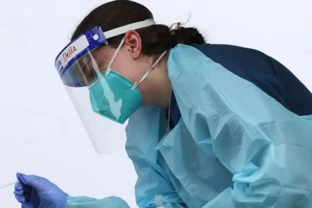 A medical worker administers a test for the coronavirus disease