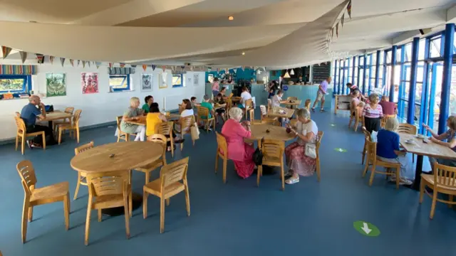 People enjoying a meal inside the Rocket House Cafe