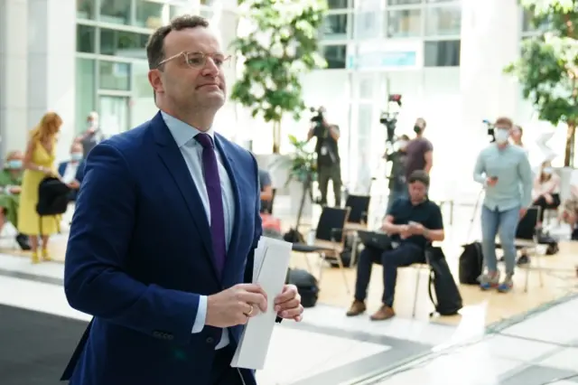 German Health Minister Jens Spahn leaves a news conference