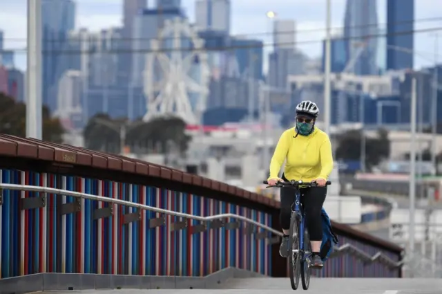 A woman riding her bike in Melbourne during lockdown