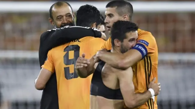 Wolves manager Nuno Espirito Santo (L) hugs his player after the game