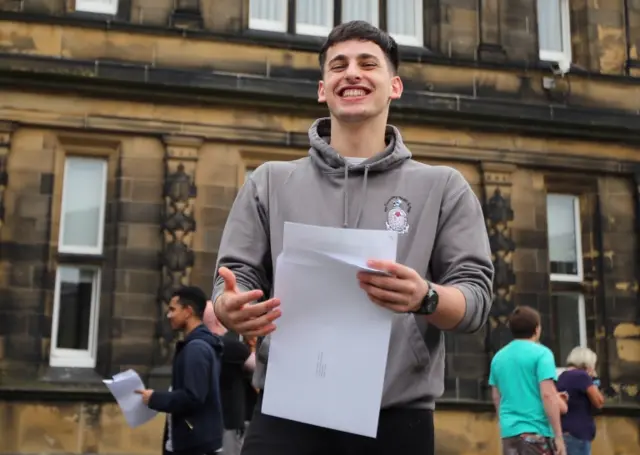 A sixth form student reacts after receiving his A-Level results at The Crossley Heath Grammar School,