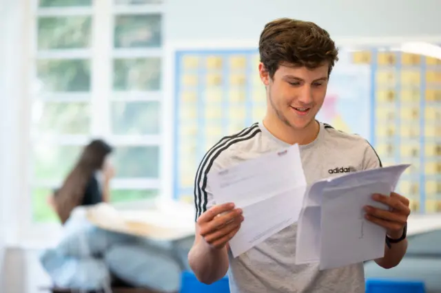 Henry Muxworthy with his A Level results at Ffynone House School