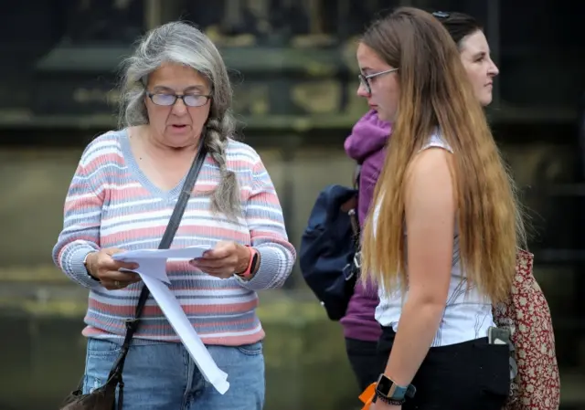 A parent reads a student's results in Halifax, Yorks