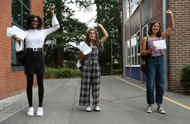 Students Gabrielle Josephs (left), Sara Al Soodi and Miriam Wilson (right) pose for a photograph after receiving their A-Level results Peter Symonds College, Winchester