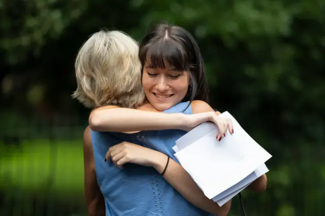 Holly Cuttiford hugs her mum after receiving her A Level results at Ffynone House School in Swansea