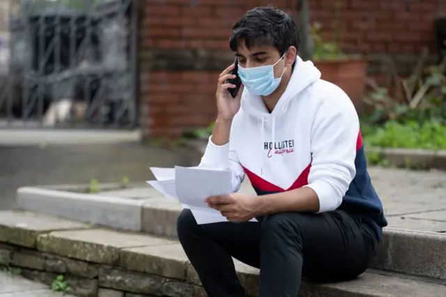 Student wears a blue surgical face mask in Swansea