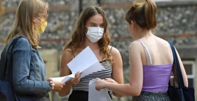 Students in face masks getting results