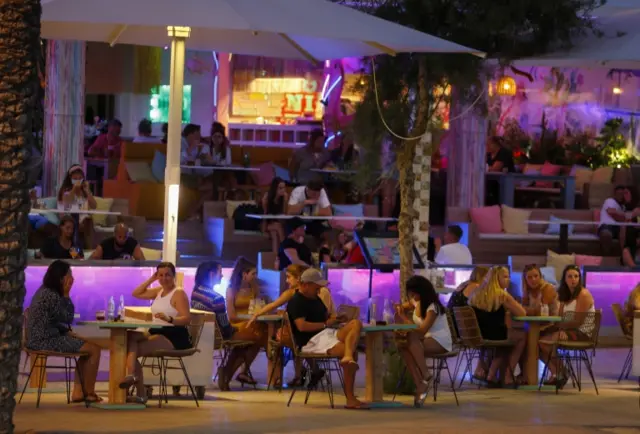 People sit at a bar in Mallorca