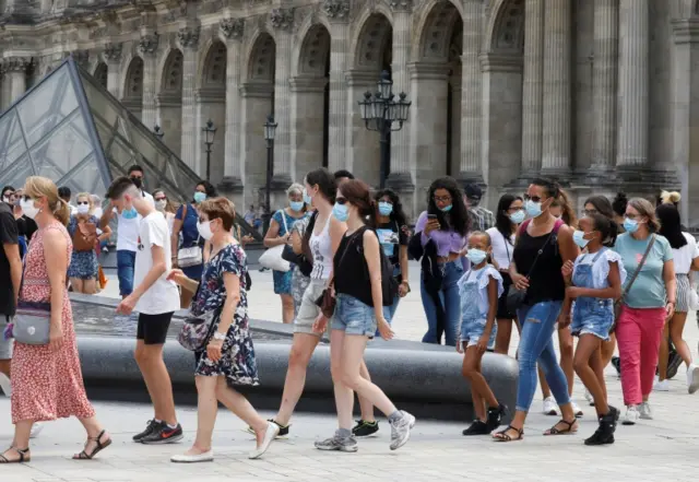 People wear face masks in Paris