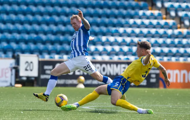 Kilmarnock's Chris burke is tackled by Jason Kerr