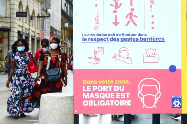 People stroll down Bordeaux's main shopping street Sainte-Catherine, where wearing a mask is compulsory