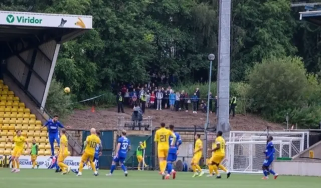 Fans watch the game from a social distance