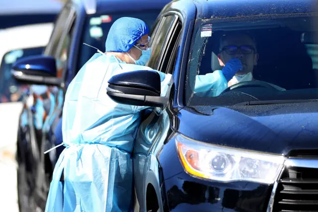 A nurse tests members of the public at the Eden Park testing station on August 16, 2020 in Auckland, New Zealand