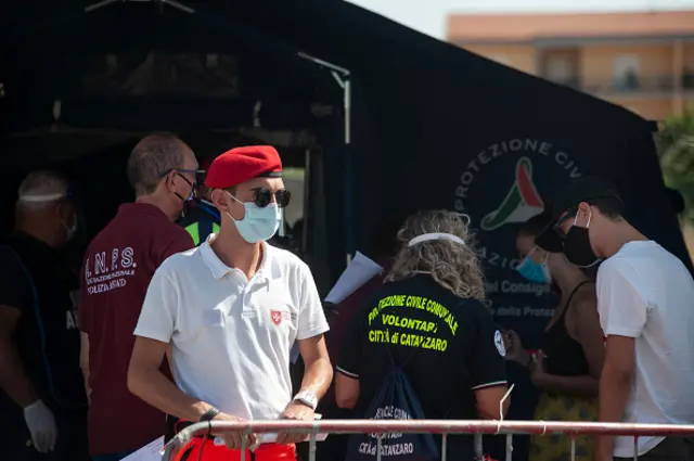 A man from "Ordine di Malta" wearing a face mask outside the Triage tent