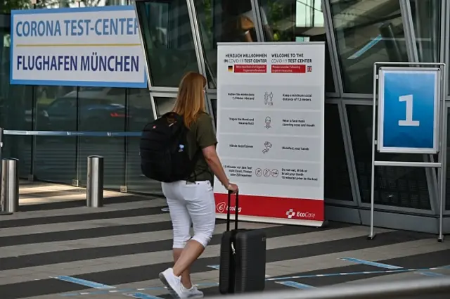 A woman enters a coronavirus testing point at Munich airport