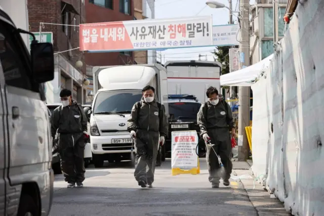 Workers disinfect the streets of the South Korean capital Seoul