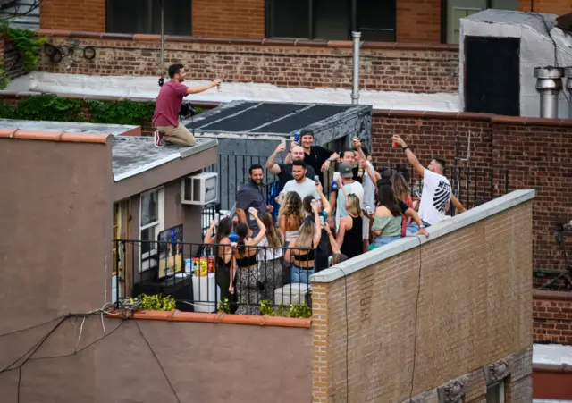 People party on a rooftop in Kips Bay as the city continues Phase 4 of re-opening following restrictions imposed to slow the spread of coronavirus on August 1, 2020 in New York City