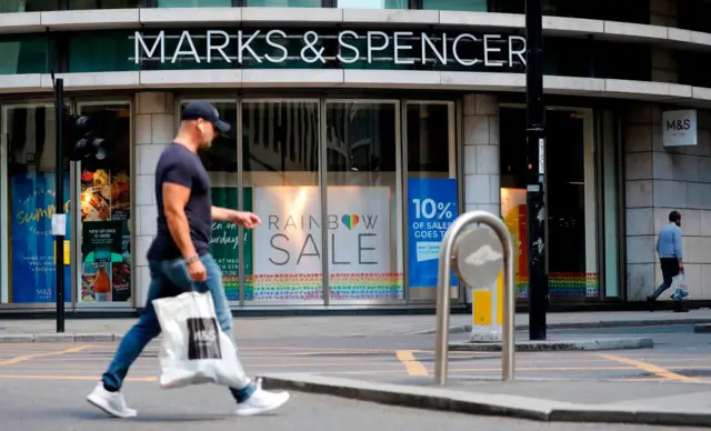 A pedestrian walks past an M&S (Marks and Spencer) store in central London on July 20, 2020