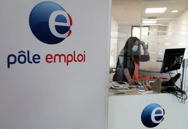 File picture of an employee wearing a protective face mask at a National Agency for Employment (Pole Emploi) office in Antibes (June 2019)