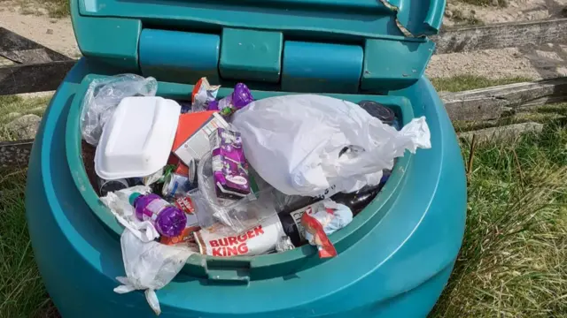 Grit bin filled with litter