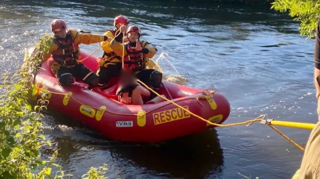 Boy being rescued in a boat