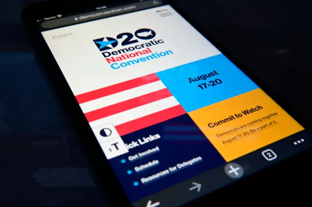 The mobile front page of the Democratic Convention website is displayed the screen of a phone, photographed on August 12, 2020 in Philadelphia, PA, USA